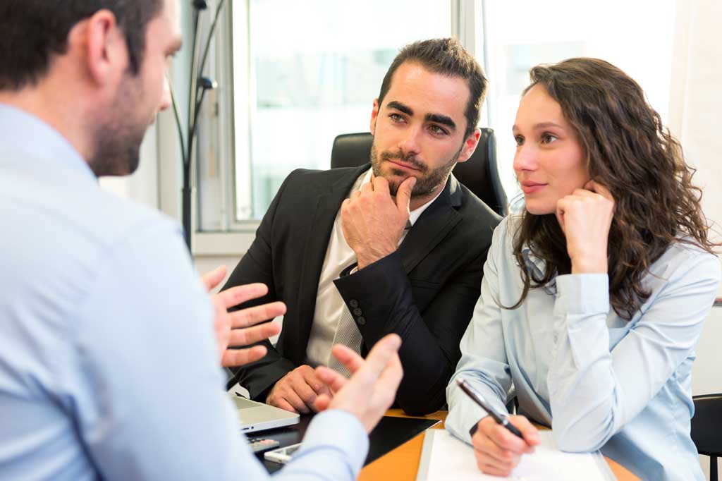 Get a FREE Consultation Husband and wife discuss estate planning with attorney
