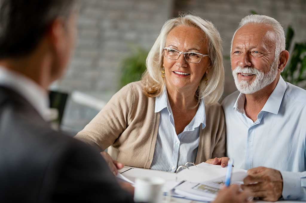 Older couple sits with attorney