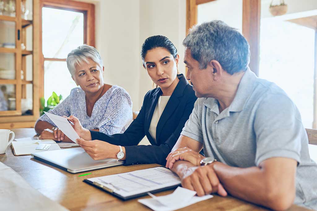Couple going over divorce documents in attorney's office.