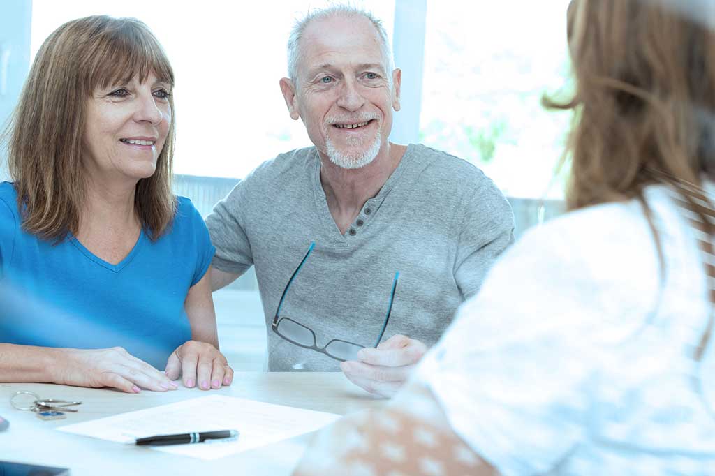 Estate Planning Middle aged couple discussing with legal counsel